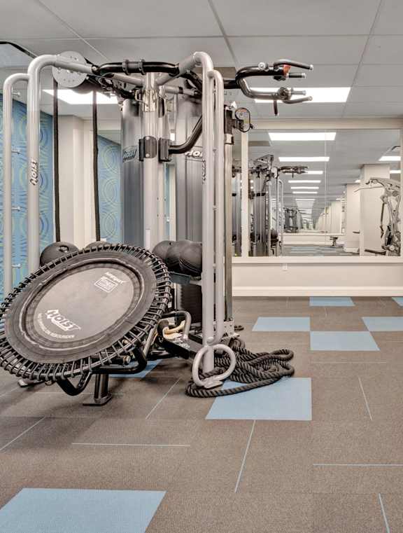 A large metal door is open to a long, empty hallway.