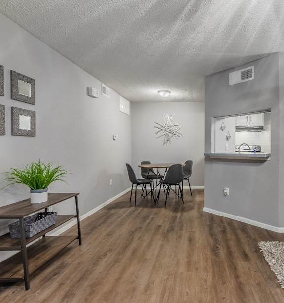 A living room with a dining table and chairs.