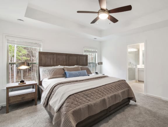 a bedroom with a bed and a ceiling fan