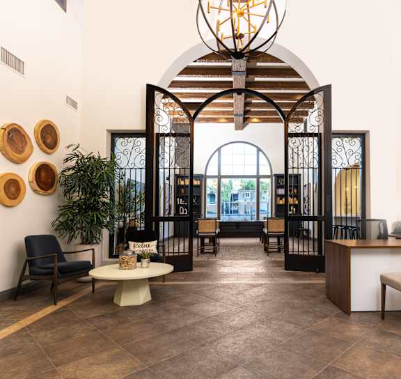 a living room with a fireplace and a table and chairs at Sonoma at Mapleton Apartments, West Murrieta, 92563