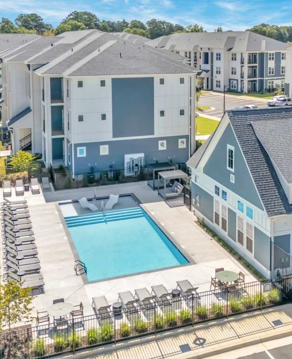 A large building with a pool in front.
