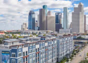 Thumbnail 1 of 33 - an aerial view of an apartment building with a city in the background