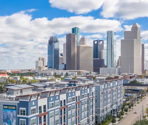 an aerial view of an apartment building with a city in the background