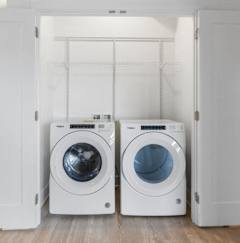 a washer and dryer in a white closet