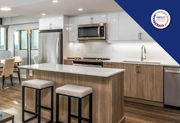 A modern kitchen with a dining table and chairs.