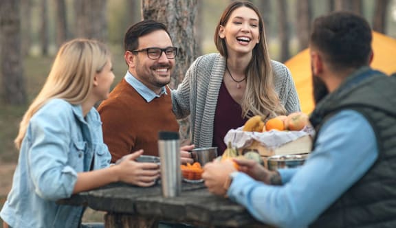 a group of friends sitting on a picnic blanket