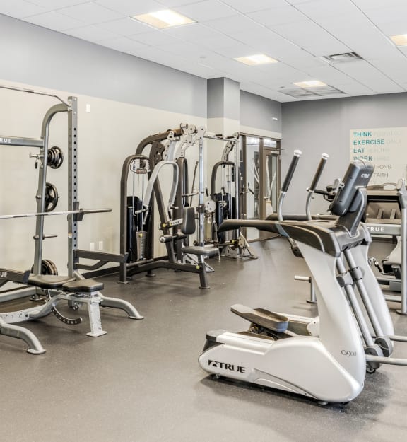a gym filled with cardio equipment and weights