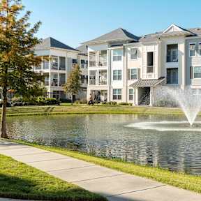 Walking path around the pond in front of an apartment building