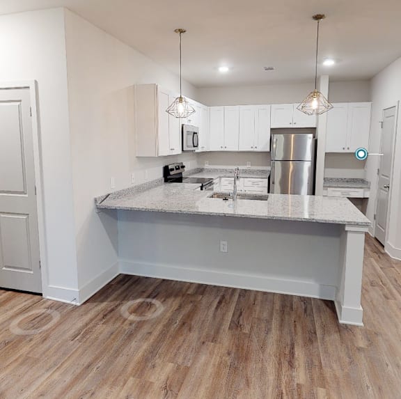 a kitchen with a counter top and a refrigerator at Midtown Row, Montgomery