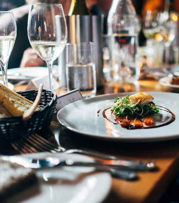 A person is holding a plate with food on it.