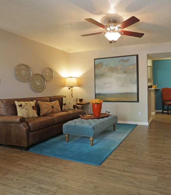 a living room with a ceiling fan and hardwood floors at Vizcaya, Santa Fe, New Mexico
