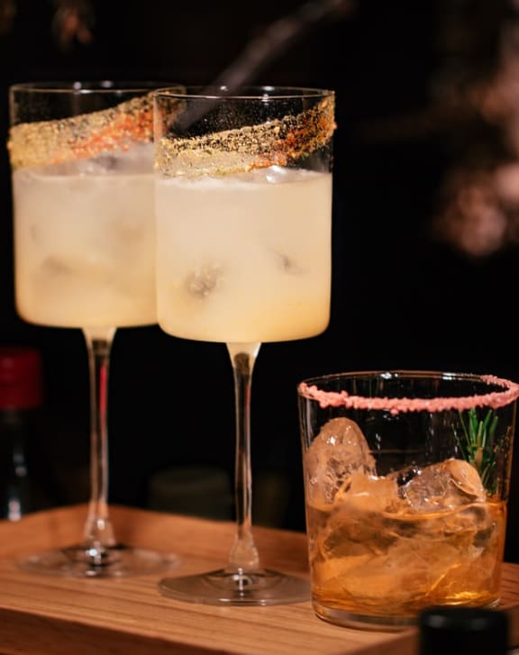 a trio of cocktails on a wooden tray at Flats at Iron Ridge, Ferndale, MI