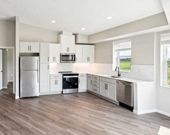 kitchen with stainless steel appliances and a window above the sink