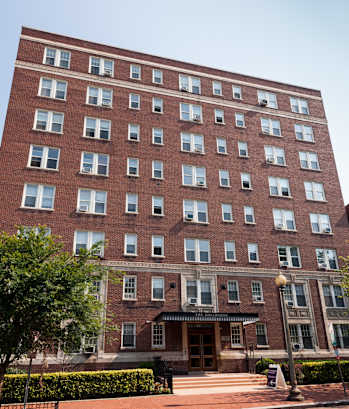 a tall brick building with a car parked in front of it