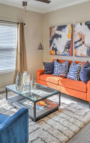 a living room with two couches and a glass coffee table at The Atlantic Stonebriar, The Colony, TX 75056