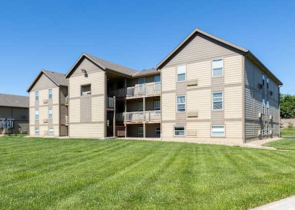 the view of two apartment buildings with a grass yard