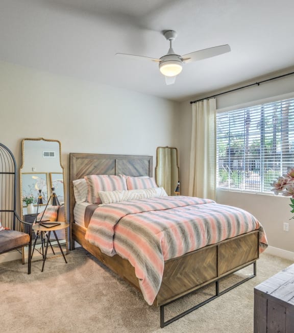 a bedroom with a bed and a ceiling fan