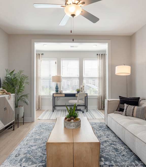 A modern living room with a blue couch and a coffee table.