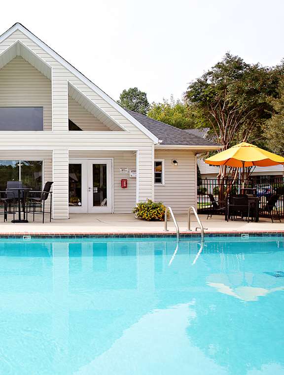 A house with a pool in front.