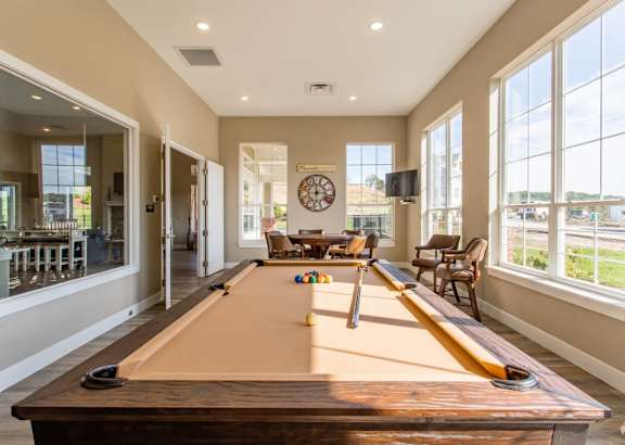 a pool table in a living room with large windows at The Flats at Summit Station, South Park, 15129