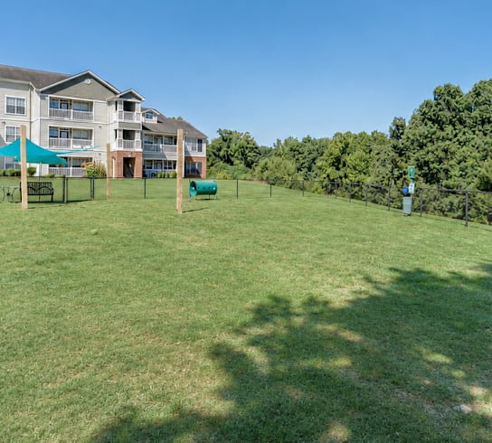 A grassy field with a building in the background.