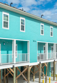 a blue and on stilts in front of a street