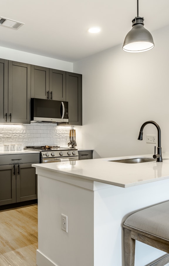 a kitchen with a island and a stainless steel refrigerator at The James at Chatham Hills, Westfield, IN