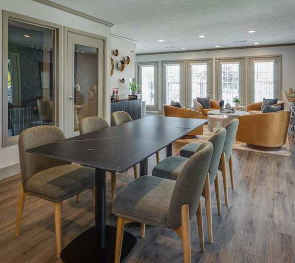 A dining room with a long table and chairs.