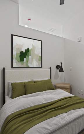 A bedroom with a bed, nightstand, and a painting on the wall.