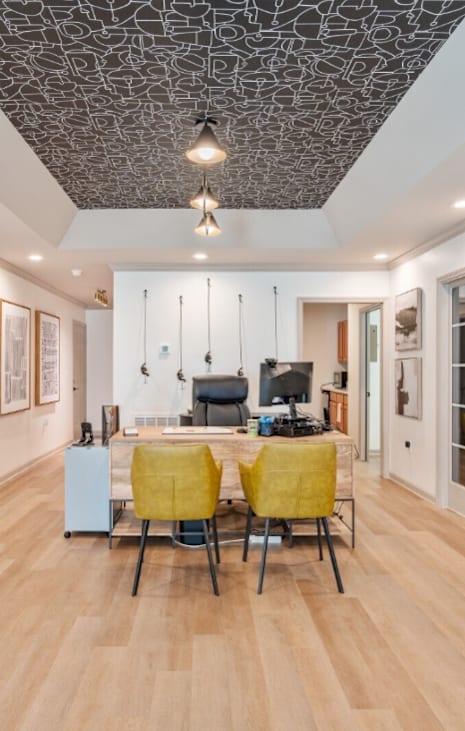 a dining room with a table and chairs in a room with glass doors