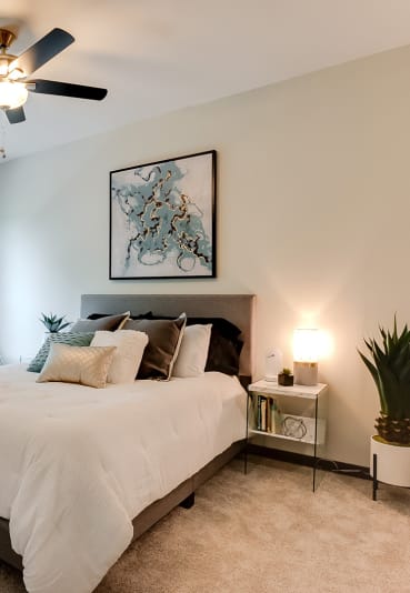 spacious bedroom with ceiling fan at Lake Jonathan Flats community
