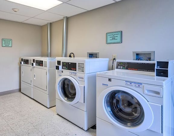 a washer and dryer in a laundry room with washes and washing machines