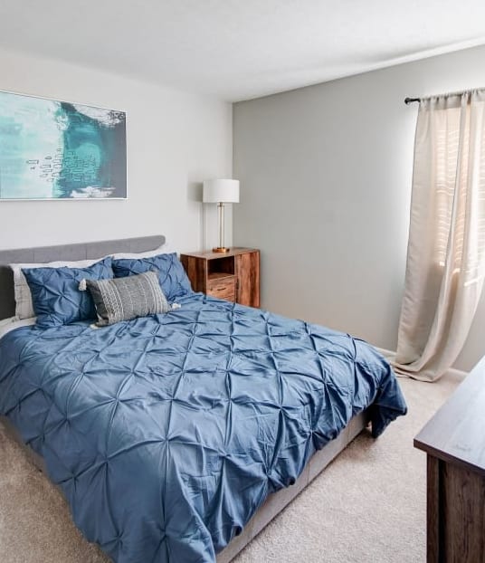 a bedroom with a bed and two night stands