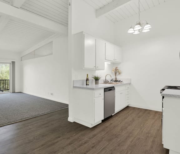 an open kitchen and living room with white walls and wood floors at Willow Tree Apartments, Torrance, CA, 90505