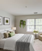 a bedroom with a bed and a chair and a television