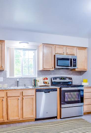 A kitchen with wooden cabinets and stainless steel appliances.