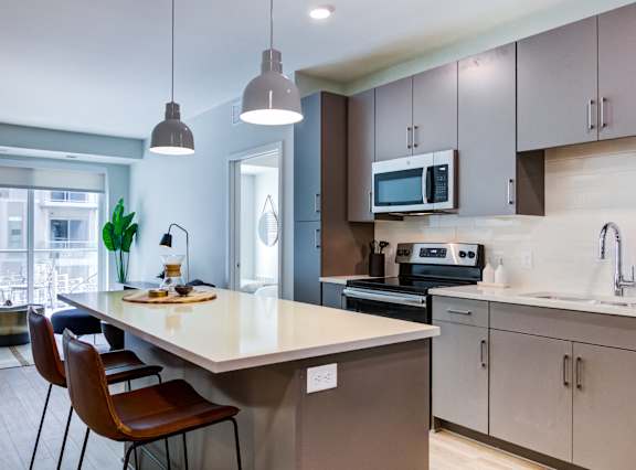 A kitchen with a table and chairs.