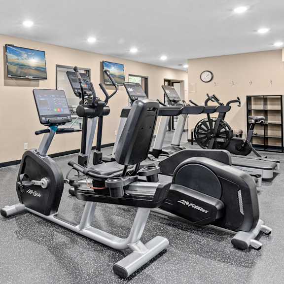 A gym with a row of exercise bikes.