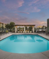 Reveal Apartments Pool with Lounge Chairs at Dusk