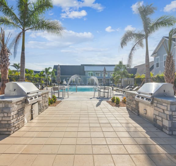 a resort style pool with two hot tubs and palm trees  at Palm Grove, Ellenton, FL, 34222