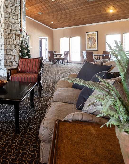 The exterior of the Cedar Crest Apartments clubhouse, featuring a well-maintained entrance and surrounding landscaping.
