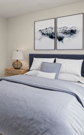 a bedroom with a bed and two pictures on the wall