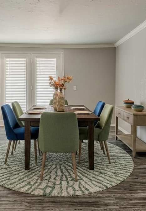 A dining room with a table set for four.