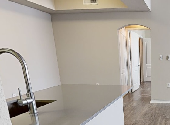 A kitchen with a stainless steel sink and wood flooring at 2803 Riverside, Grand Prairie, Texas