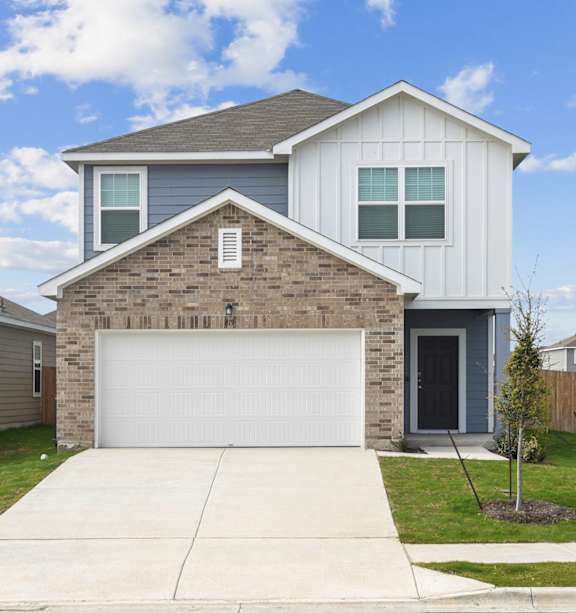 a house with a white garage door at Beacon at Hymeadow, Maxwell, TX