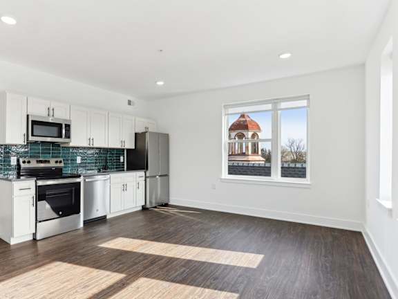 A kitchen with a black and white color scheme and a large window.