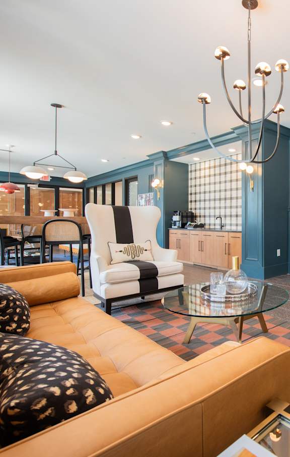 a living room with blue walls and furniture and a tv at The Fitzgerald in Spartanburg, SC 29302