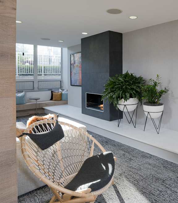 a living room with a chair and a fireplace