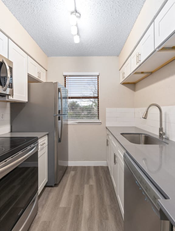 a kitchen with stainless steel appliances and a sink