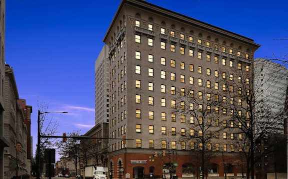 A view of a city with the American National Bank building in the foreground.